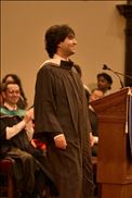 A photograph of me, Hassan Khan, looking up and to the right dressed in graduation regalia.